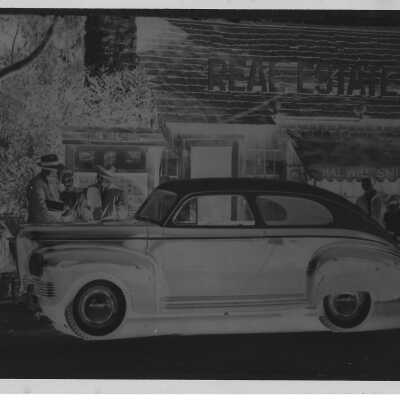 Negative 1941 Nash Ambassador Advertisement in front of Hal Will Smith Realty