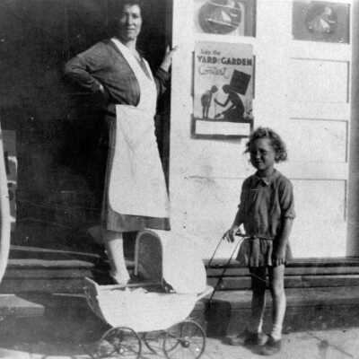 Woman and Girl in front of Wallies Market