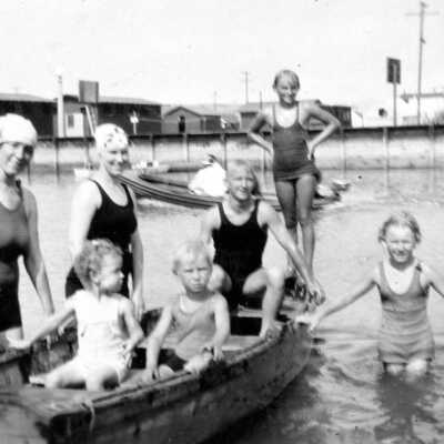 Women and Children with Boat Playing in Bay