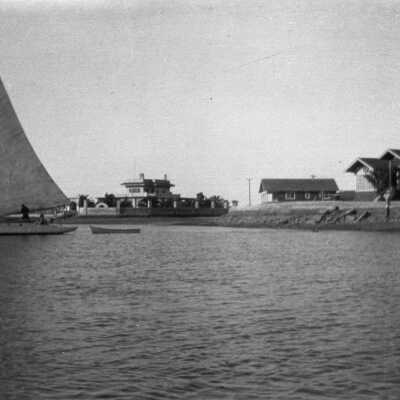 Sailboat Towing a Dinghy in Newport Harbor