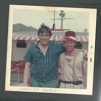 Bert Minshall Wearing a Fez, Standing with Neville Brand