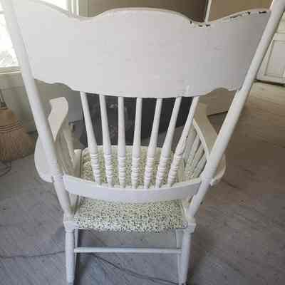 back view: White chair with light indentations in the wood