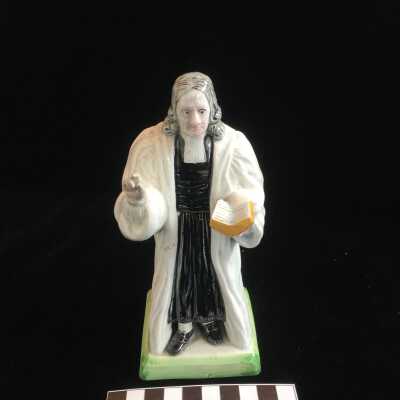 Sculpture of Wesley in a White Robe Holding a Yellow Bible