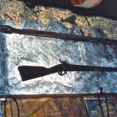Gun and Harpoon on Wall