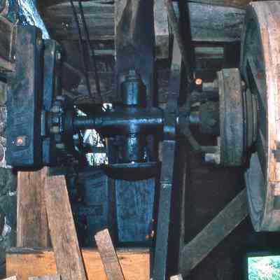 Clutch handle, cider press pulley, axle going inside first floor