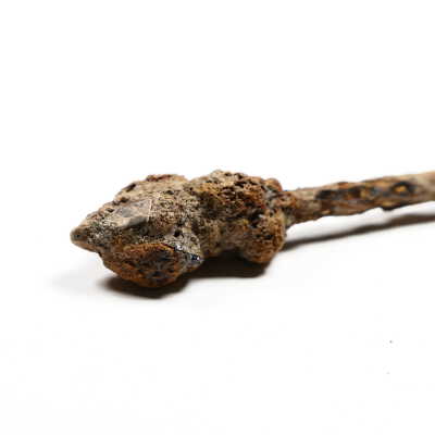 small shard of glass embedded in iron corrosion