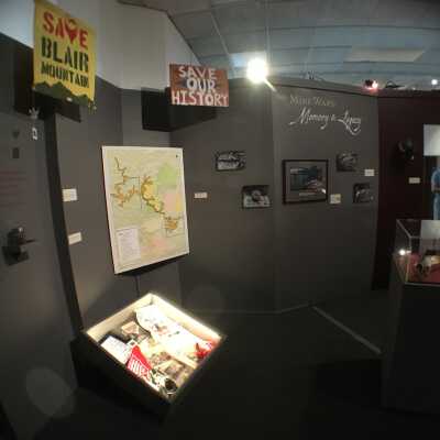 exhibition view of sign placement in museum, part of The Mine Wars: Memory & Legacy