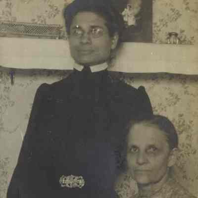 Two unidentified women, one standing (most likely Phoebe Litzel) on the left and one seated (most likely Louisa Litzel) on the right