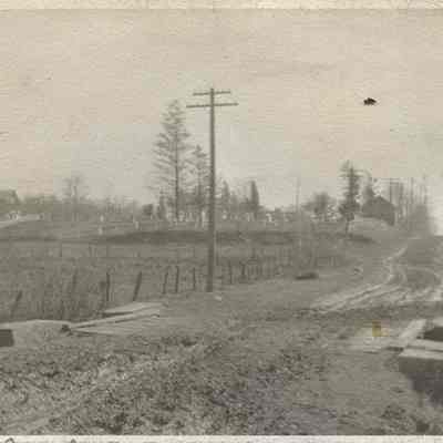 1915, Lee Road looking south from Van Aken Boulevard. Lee was not yet paved, and Warrensville West Cemetery is visible in the background.