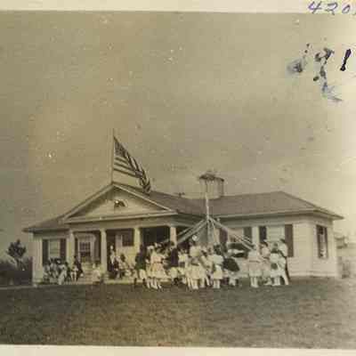 420.18 - Students with a maypole in the lawn of Shaker Heights Village School, located in the Van Sweringen sales office at Lee Road and Shaker Boulevard.