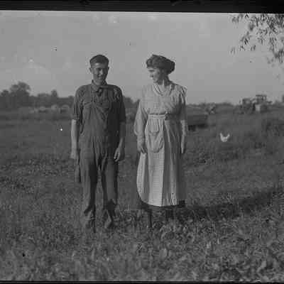 Man and Woman Standing in a Field