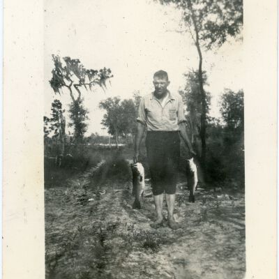 Man Holding Two Fish