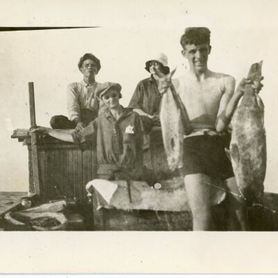 Four (4) People on a Boat with Fish