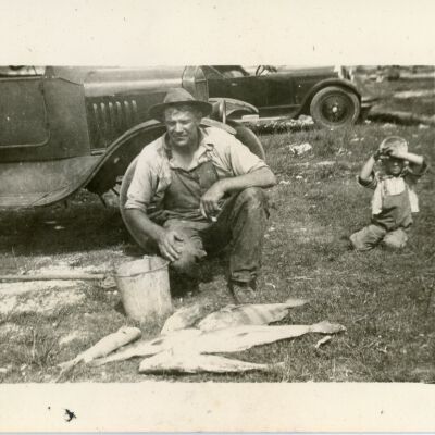 Man and Small Boy with Fish