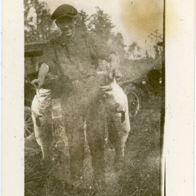 Man Holding Two (2) Fish