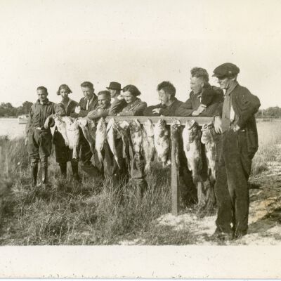 Men and Women with Hanging Fish