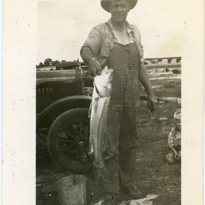 Man and Small Boy with Fish