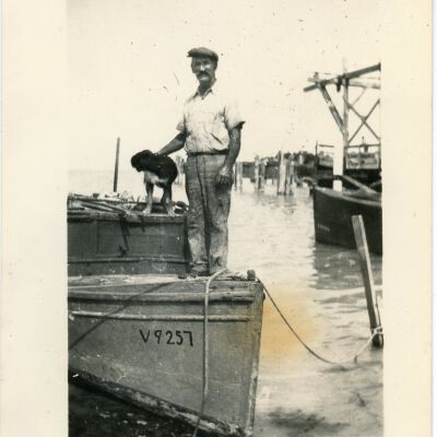 Man and Dog on Docked Boat