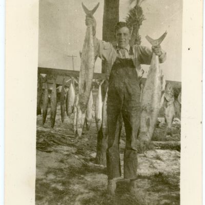 Man Holding Two (2) Fish