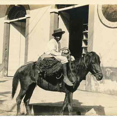 Boy Sitting on a Pony