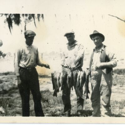 Three Men Holding Fish