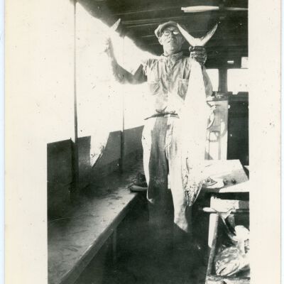 Man Holding Two (2) Fish