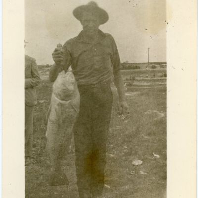 Man Holding Up a Fish