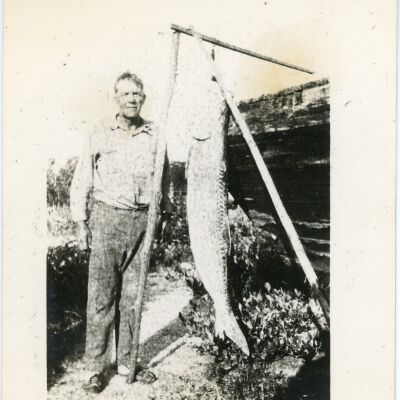 Man Standing by Fish
