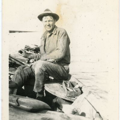Man Steering a Motorboat