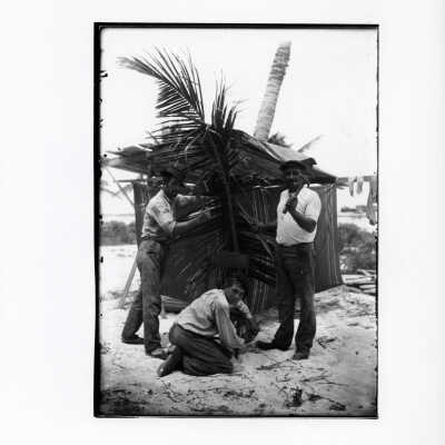 Three Men Repairing a Chair