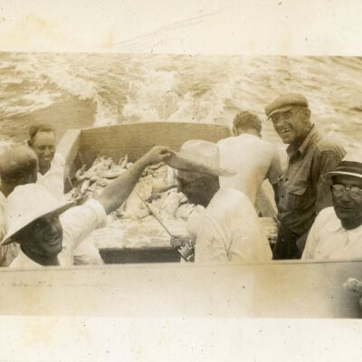 Seven (7) Men on a Boat with Fish