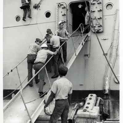 U.S Navy Personnel Bringing Supplies Aboard