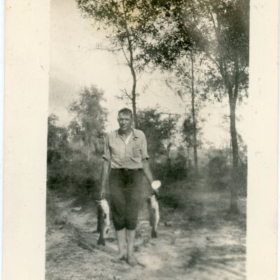Man Holding Two (2) Fish