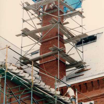 Unknown people working on the chimney.