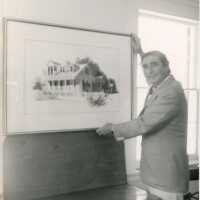 An unknown man holding a piece of art work
