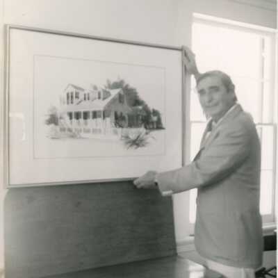 An unknown man holding a piece of art work