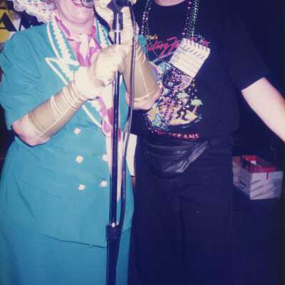 Two unknown people talking at a microphone.