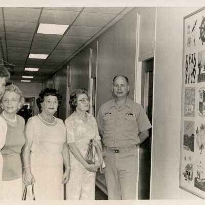 USCG man and woman with unknown people