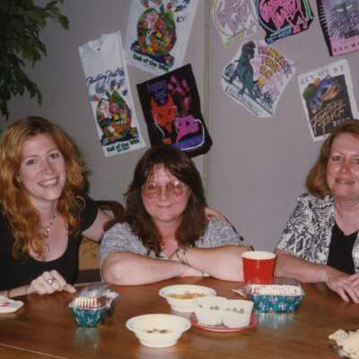 Three unknown woman sitting at a table.