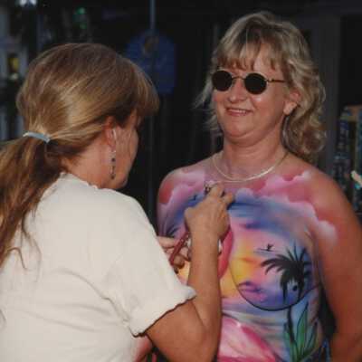 Unknown lady having her breast painted.