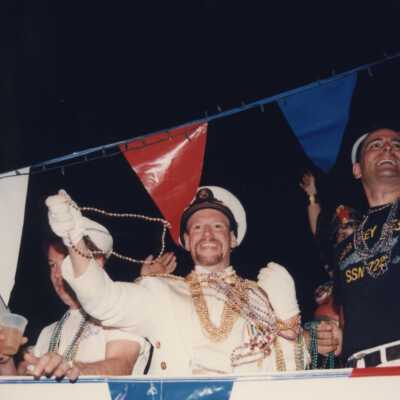 Unknown men dressed up on a float.