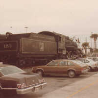 Cars parked near Gold Coast Railroad Locomotive #153