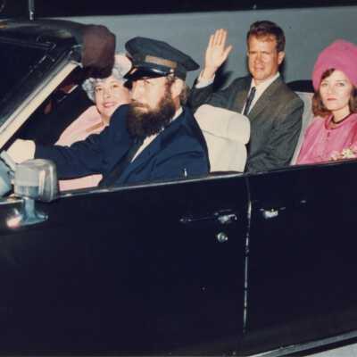Unknown people in a convertible.