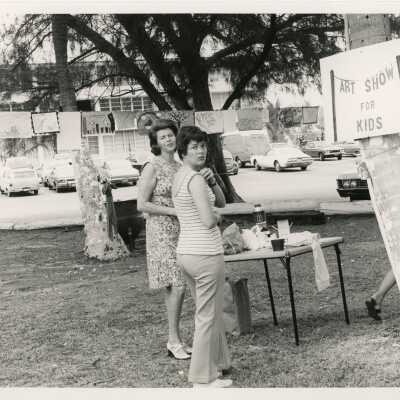 Unknown woman standing at a kids art show