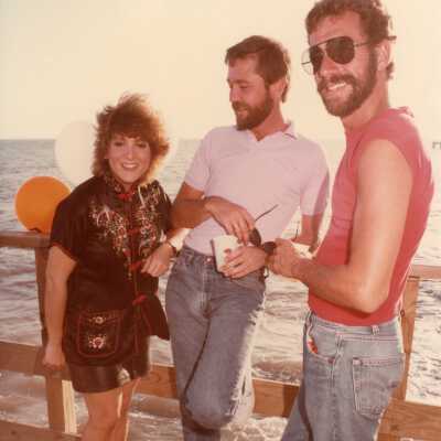 Three unknown people at some sort of FF party.