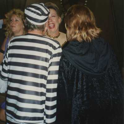 Unknown people dressed up talking to each other.