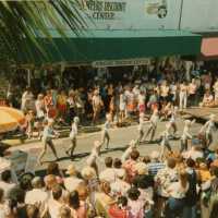 A group of unknown people dancing in the street.