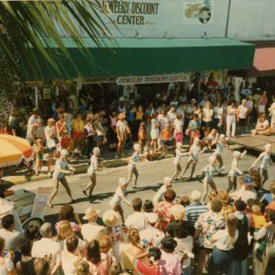 A group of unknown people dancing in the street.
