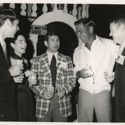 An Unknown group of people talking at a party