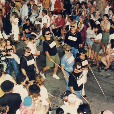People in the parade walking down Duval Street.
